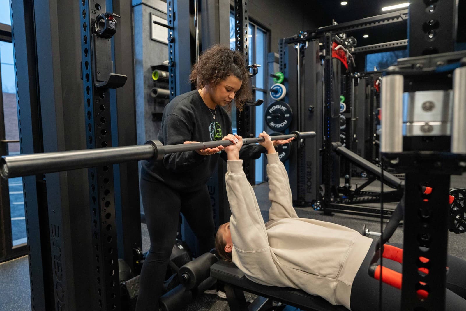 Terrence coaching a client through strength work at Untapped Potential Performance